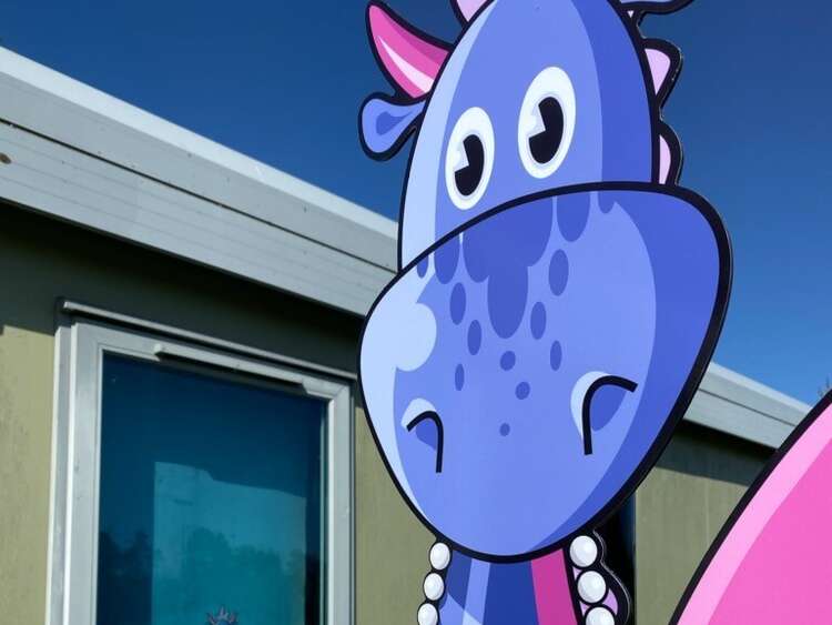 Exterior colourful dragon mascot sign as part of nursery signage rebrand