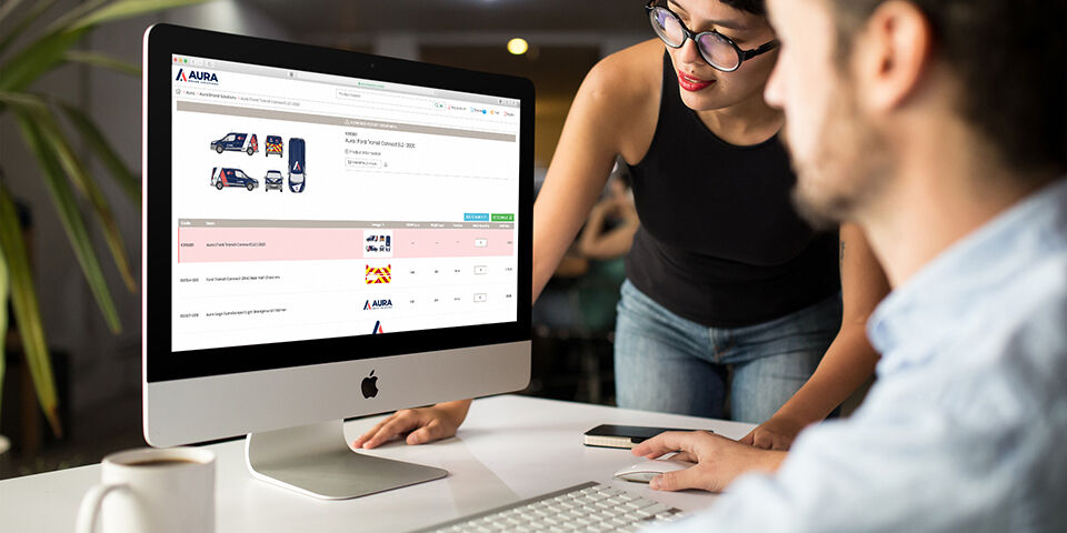 Man and woman in office using Aura Brand Solutions online ordering system