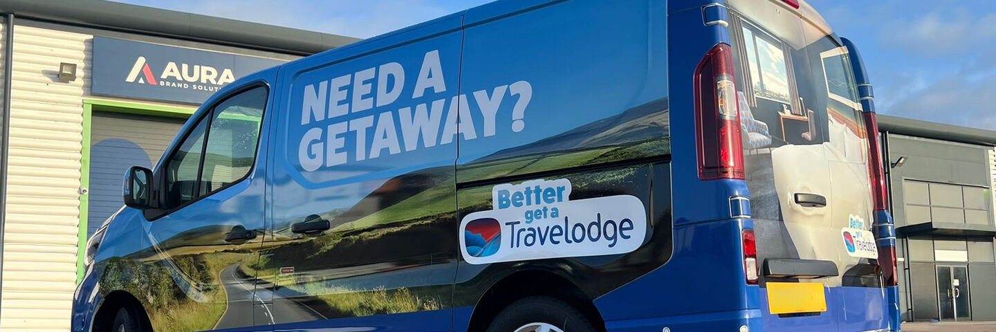 Need a Getaway? Travelodge Van in front of Aura Installation Centre