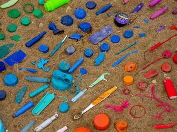 colourful plastic waste on beach sustainability