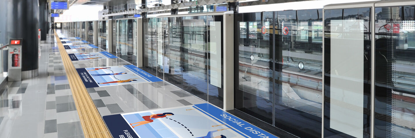 Health and safety graphic on the floor of a train station platform