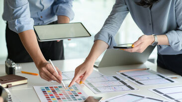 Design team discussion with tablet