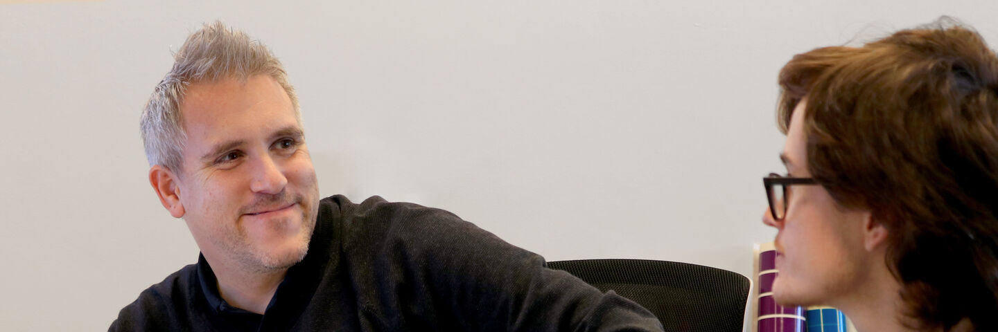 Aura team members discussing brand solutions