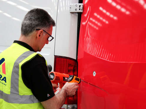 Expert vehicle wrap installation technician at work