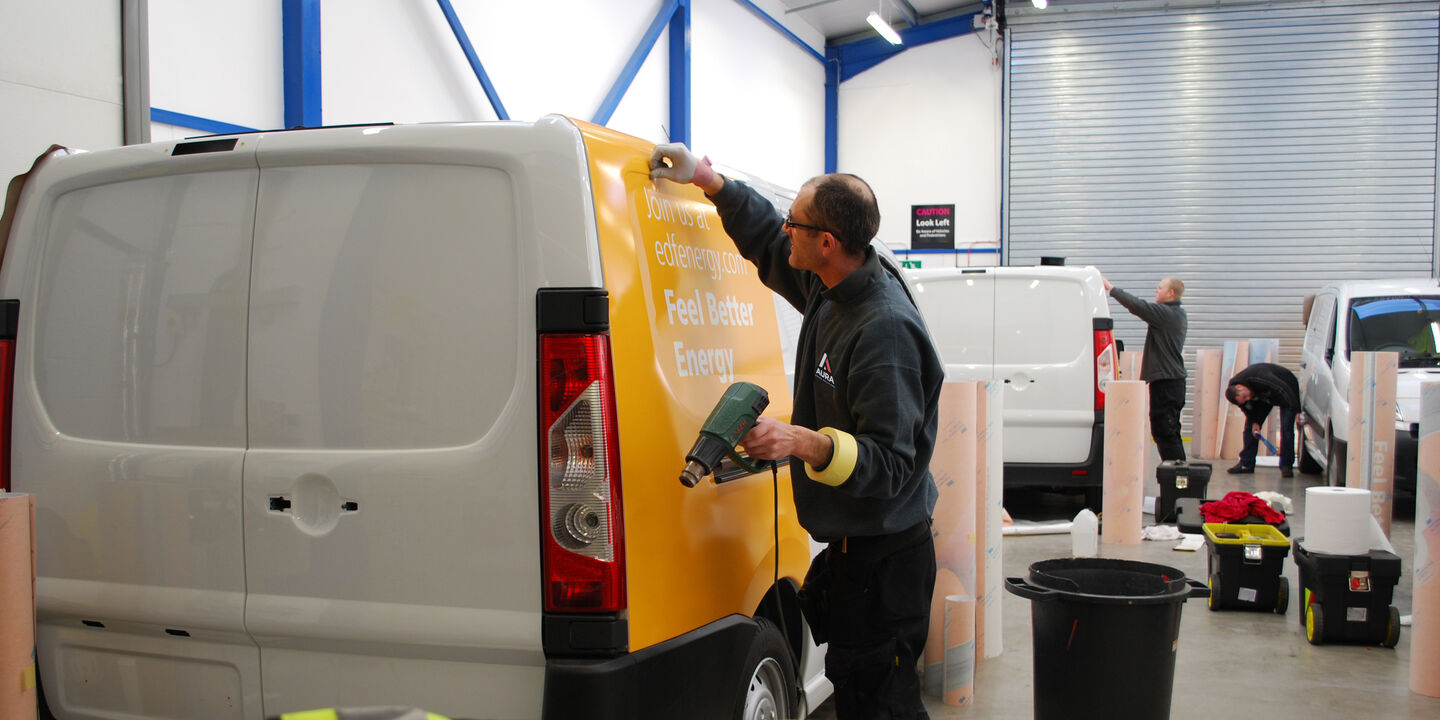 Aura Brand Solutions installing vehicle wrap