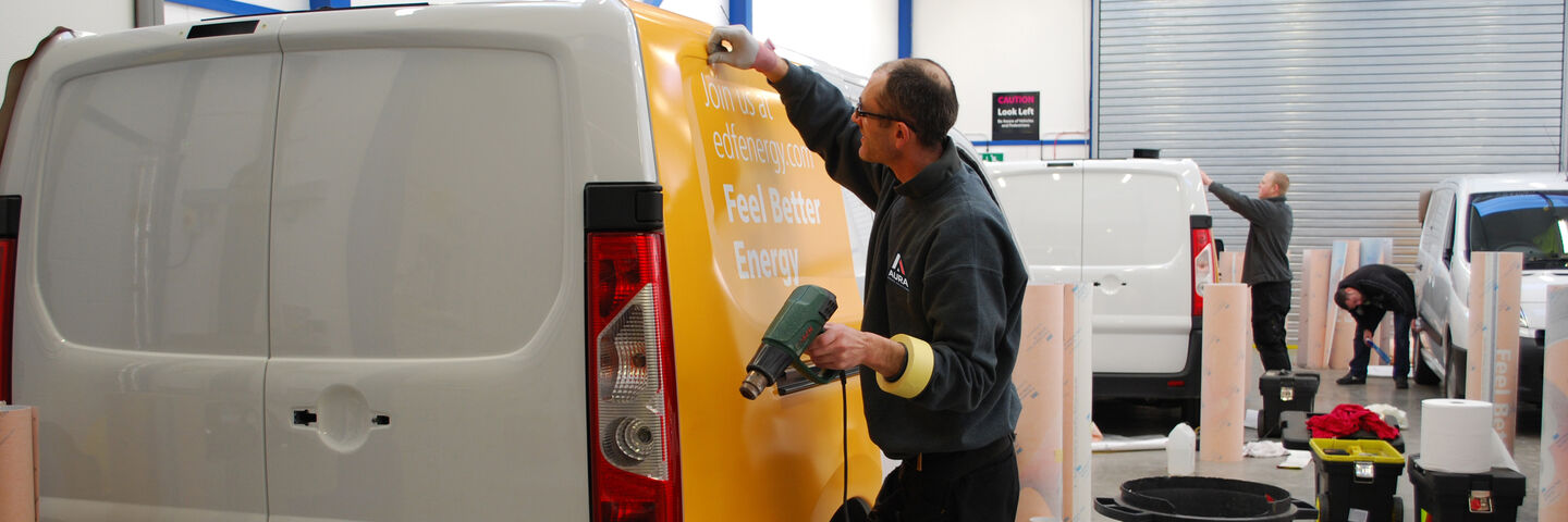 Aura Brand Solutions installing vehicle wrap
