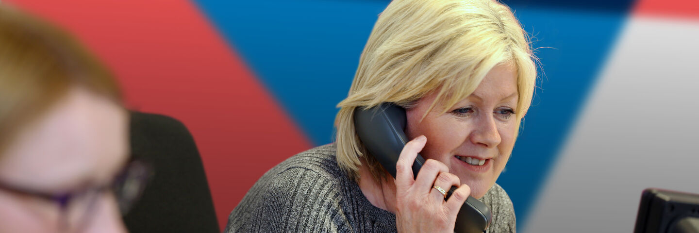 Office workers answer phone calls at Aura brand solutions Stoke office