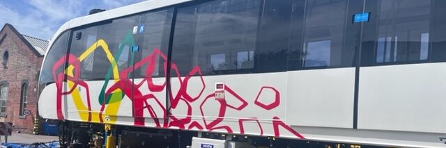 Side view of red Cairo Monorail livery wrap outdoors