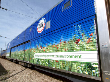 Complex promotional train wrap to corrugated body of Eurotunnel double-deck loader