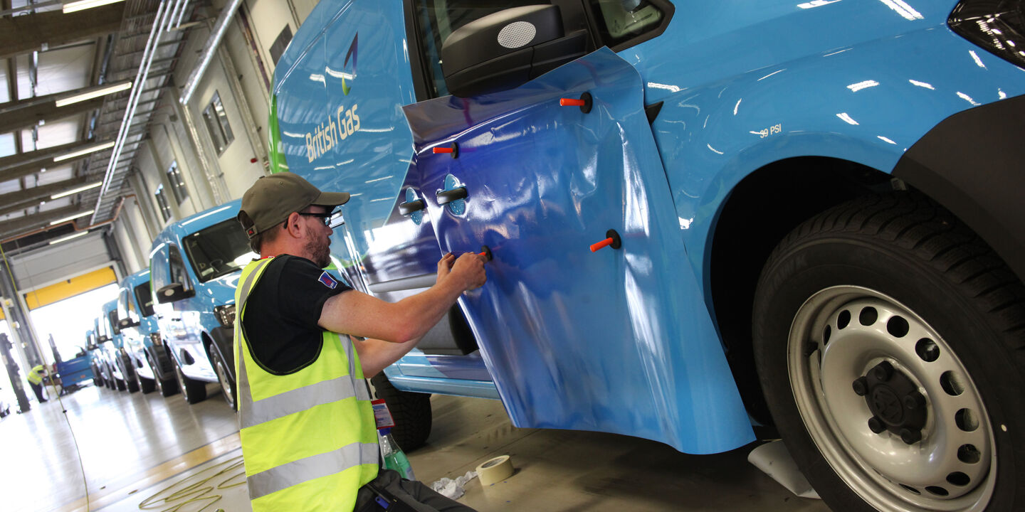 Aura technican installing commercial van graphics for British Gas fleet livery