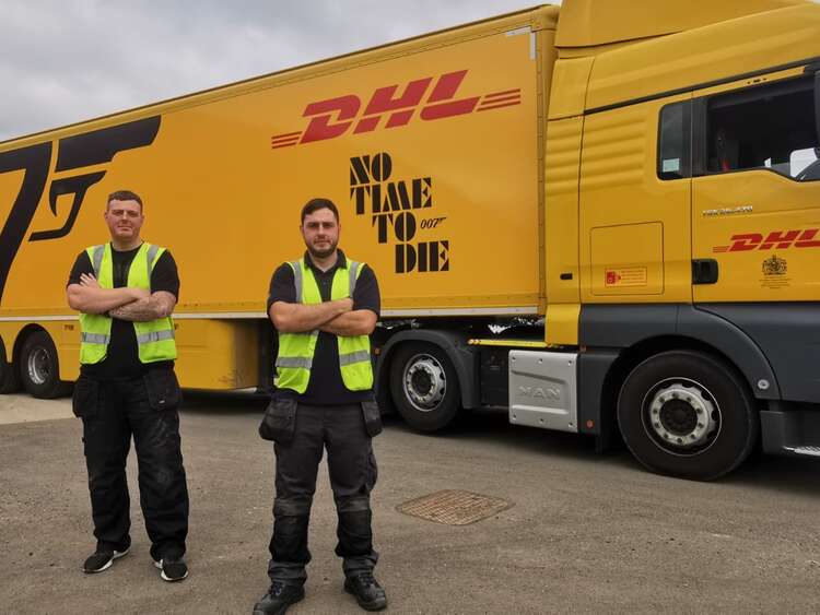 Aura Brand Solutions Installers with freshly wrapped DHL Trailer advertising 2021 James Bond Film