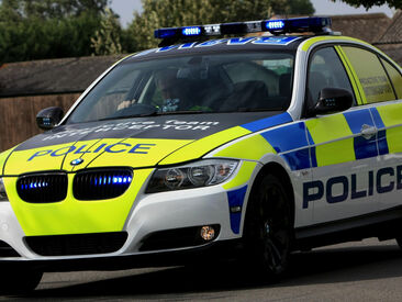 Reflective conspicuity livery and safety markings on police emergency service vehicle