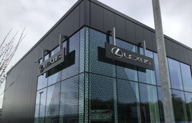 Window film pattern graphics applied to exterior glass frontage of Lexus car dealership