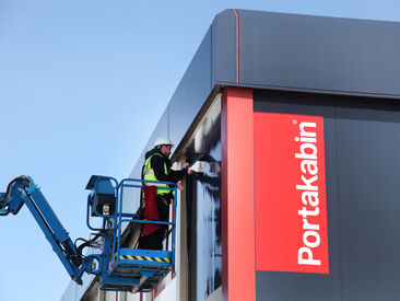 High-level installation of printed building wrap for Portakabin