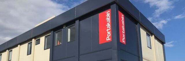 After shot of Portakabin exterior branding with building wrap and logo signage